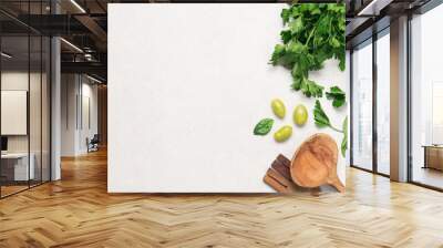 Parsley, spinach, cherry tomatoes with kitchen utensils on white background with copy space. Food background top view Wall mural