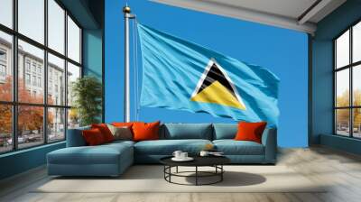 Saint Lucia national flag waving against clear blue sky Wall mural