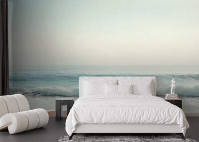 Serene beach scene with soft waves and misty horizon Wall mural