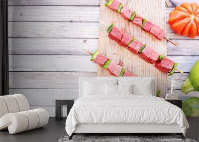 Raw  pork or beef on skewers with fresh veggies on wooden table ready for bbq. Barbecue ingredients with copy space.  Wall mural