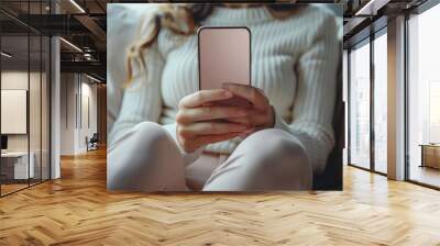 Woman Relaxing on Couch, Browsing Social Media on Smartphone with Blank Screen, Close Up Wall mural