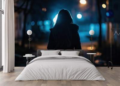 Silhouette of a young woman walking home alone at night, scared of stalker and being assault, insecurity concept Wall mural