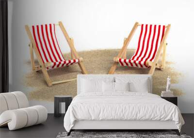 Striped beach chair on sand isolated on white background Wall mural