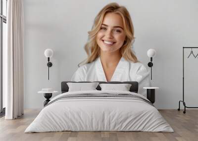 Stunning smiling blonde in white robe spa Wall mural