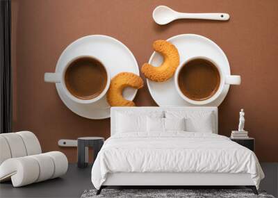 Two cups of coffee with spoons on a brown paper background. Wall mural