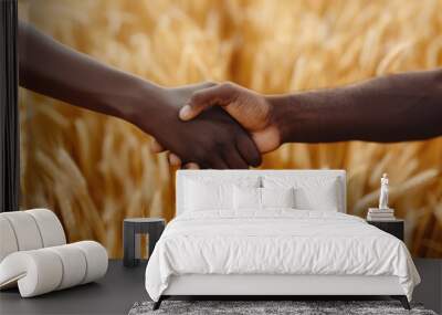 Two hands shake firmly in a golden wheat field. Unity, partnership, and agricultural concepts. Wall mural