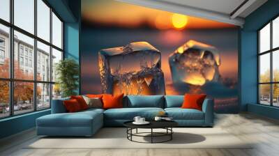 two ice cubes are shown in the snow at sunset or sunrise, with the sun setting in the background and the ice on the ground is melting and the water is orange and the ice. Wall mural