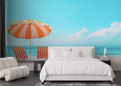 Two striped orange and white deck chairs under a beach umbrella on the shore. The concept of a banner or flyer advertising a beach holiday Wall mural