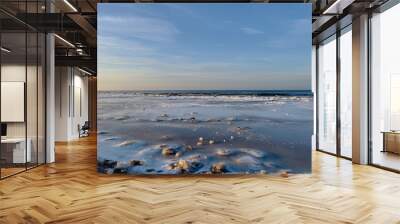 Winter landscape with sea covered with ice and blue clear sky above, selective focus Wall mural