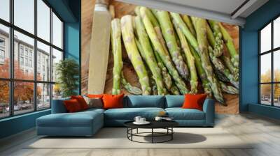 Green asparagus and knife on a wooden chopping board Wall mural