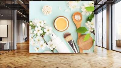 Beauty spa treatment, honey facial mask, skincare cosmetic products with natural spring apple blossom top view over pastel colored blue delicate background Wall mural