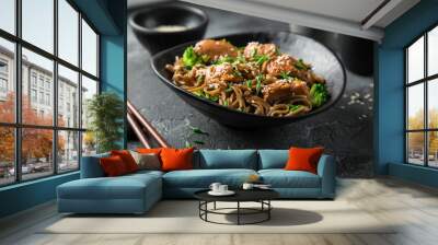 asian soba noodle and teriyaki salmon  in black bowl Wall mural