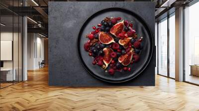 Fig, grape, raspberry and pomegranate salad on black plate Wall mural