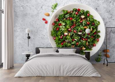 fresh kale, roasted chickpeas, almond and pomegranate salad in white bowl Wall mural