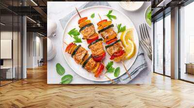 Grilled salmon and vegetables skewers on white plate Wall mural