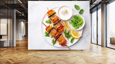 Grilled salmon and vegetables skewers on white plate Wall mural