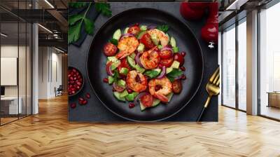 grilled shrimps and vegetable  salad on black plate Wall mural