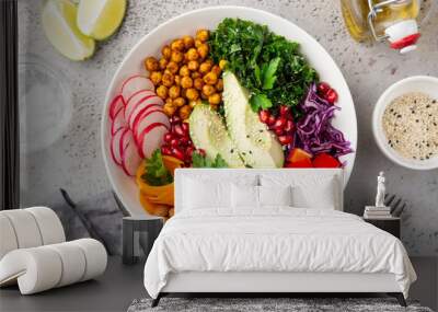 lunch bowl salad with avocado, roasted chickpeas, kale, cucumber, carrot, red cabbage, bell pepper and redish Wall mural