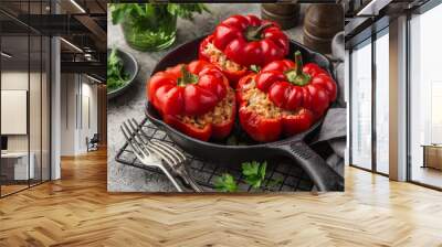 red bell peppers stuffed with meat, rice and vegetables on cast iron pan Wall mural