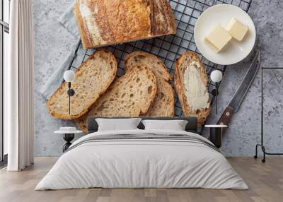 slices of freshly baked homemade sour dough bread with butter Wall mural