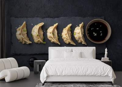 Traditional japaneese gyoza dumplings on black slate plate Wall mural