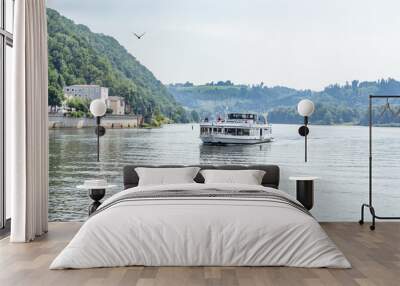 A boat drives on a river in Passau, bavaria Wall mural