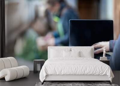 Horse owner as digital online clients: A laptop in front of blurred horse and owner paddock scene, consulting online advice and online shopping as horse owner Wall mural