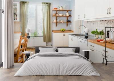 banner of a kitchen with kitchen table  and breakfast at the kitchen counter top white cupboards and wooden floor Wall mural