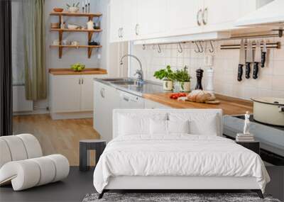 kitchen interior detail counter top with sliced bread, fresh herbs and tomatoes Wall mural