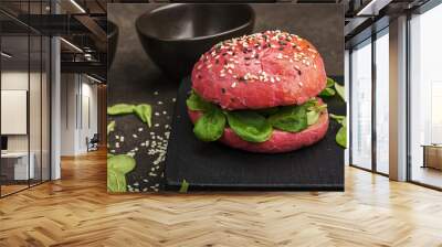 Vegetable pink burger with avocado and corn salad on a dark background. Selective focus. Wall mural