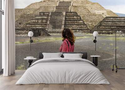 Woman in red dress standing on front of a pyramid Wall mural