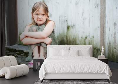 Angry little girl portrait outdoors Wall mural