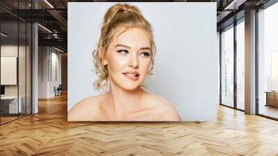 Close up portrait of beautiful young woman on white background, biting lip, looking aside, make a decision Wall mural