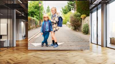 Cute kids with backpacks walking to school Wall mural