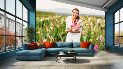 Happy laughing woman cutting gladiolus on flower farm, hobby and leisure, nature lifestyle Wall mural