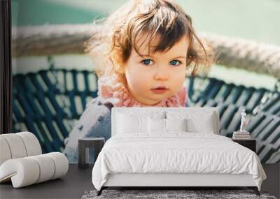 Outdoor portrait of adorable toddler girl having fun on playground, 1 - 2 year old kid playing in park Wall mural