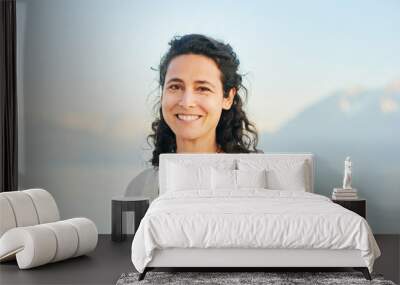 Outdoor portrait of beautiful middle age hispanic woman enjoying nice sunny day by the mountain lake Wall mural