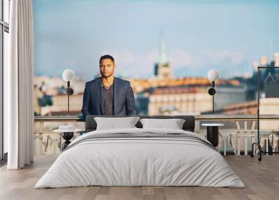 Outdoor portrait of handsome afro american man, city landscape on background Wall mural