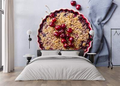 Cherry, red berry crumble in baking dish. Grey stone background. Top view. Wall mural