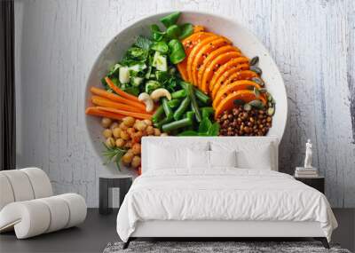 Healthy vegetarian salad. Lentil, chickpea, carrot, pumpkin, tomatoes, cucumber. Wooden background. Top view. Wall mural