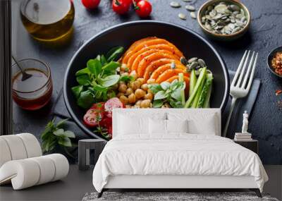 Healthy vegetarian salad. Roasted pumpkin, quinoa, tomatoes, green salad. Buddha bowl. Slate background. Close up. Wall mural