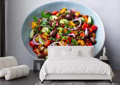 Lentil salad with vegetables in bowl. Grey background. Close up. Wall mural