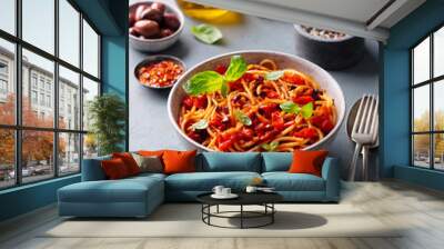 Pasta, spaghetti with tomato sauce, olives and fresh basil. Grey background. Wall mural