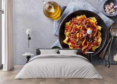 Pasta fettuccine with beef ragout sauce in black bowl. Grey background. Copy space. Top view. Wall mural