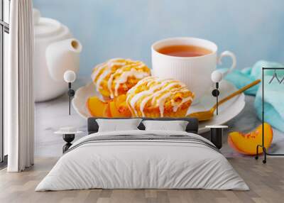 Peach cupcakes, muffins with cup of tea. Marble table. Close up. Wall mural