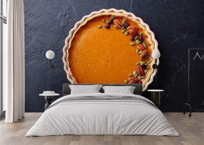 Pumpkin pie in baking dish. Dark background. Close up. Top view. Wall mural