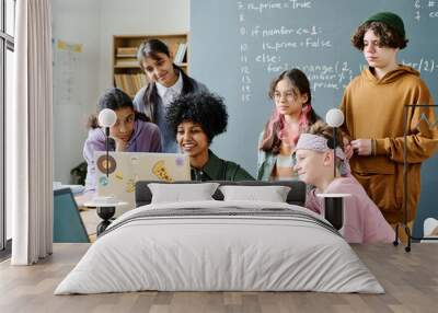 African American teacher using laptop to teach students information technology in the classroom Wall mural