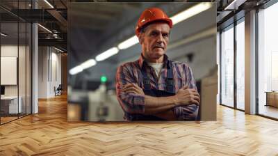 Portrait of confident senior foreman in protective work wear standing with arms crossed and looking at camera Wall mural