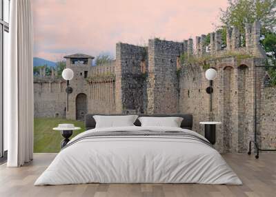 Part of the medieval fortification walls in Rocca Borromeo di Angera at Laggio Maggiore on a clouded summer day, Italy Wall mural