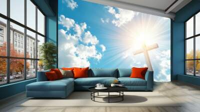 Image of a Christian cross with the rays of God on a blue sky background. Wall mural